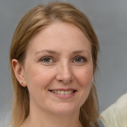 Joyful white adult female with medium  brown hair and grey eyes