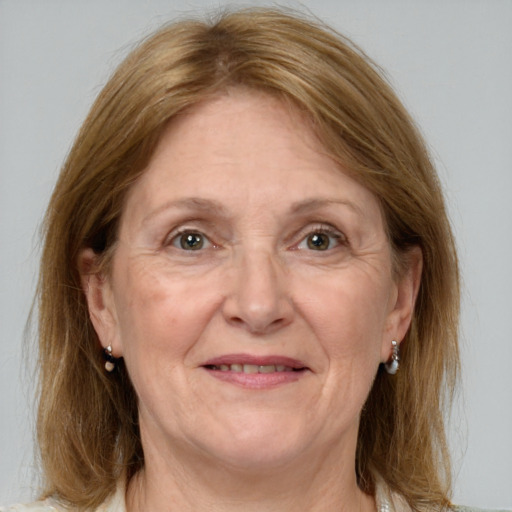 Joyful white adult female with medium  brown hair and grey eyes