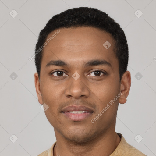 Joyful black young-adult male with short  black hair and brown eyes