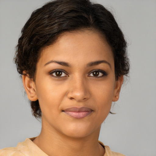 Joyful latino young-adult female with short  brown hair and brown eyes