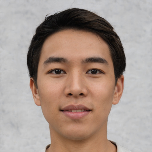 Joyful asian young-adult male with short  black hair and brown eyes