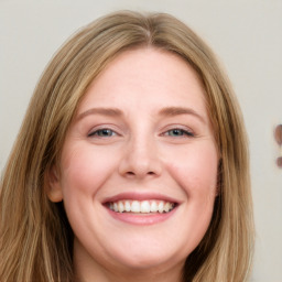 Joyful white young-adult female with long  brown hair and blue eyes