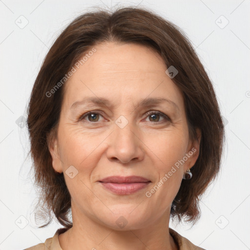 Joyful white adult female with medium  brown hair and brown eyes