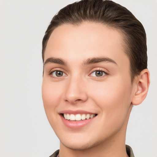 Joyful white young-adult female with short  brown hair and brown eyes