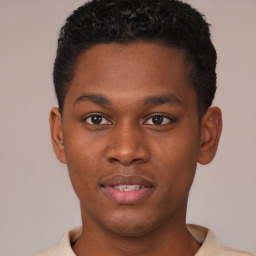 Joyful black young-adult male with short  brown hair and brown eyes