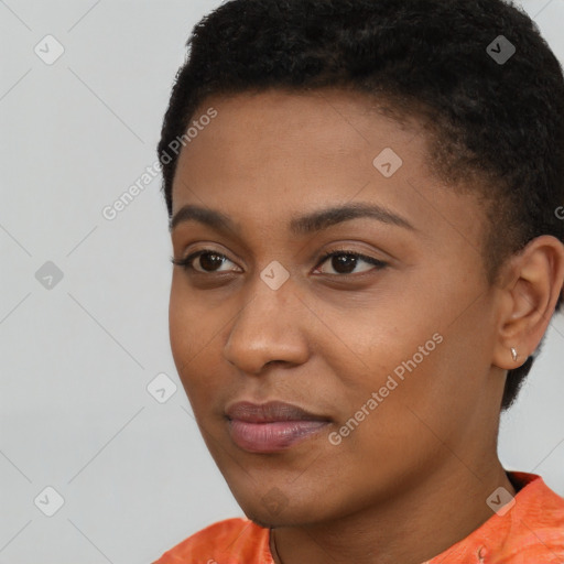 Joyful black young-adult female with short  black hair and brown eyes