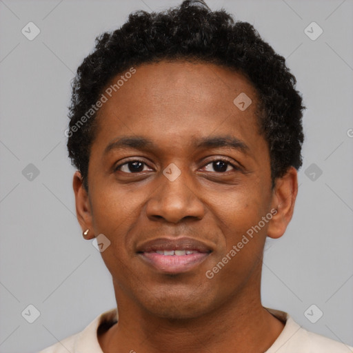 Joyful black young-adult male with short  black hair and brown eyes