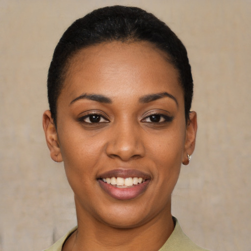 Joyful black young-adult female with short  black hair and brown eyes