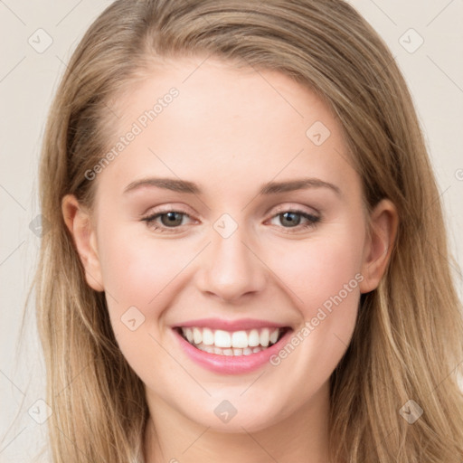 Joyful white young-adult female with long  brown hair and green eyes