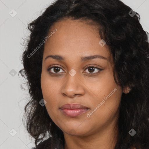 Joyful black young-adult female with long  brown hair and brown eyes