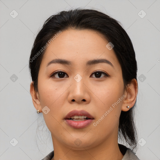 Joyful asian young-adult female with medium  black hair and brown eyes