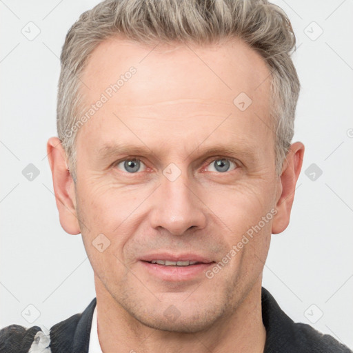 Joyful white adult male with short  brown hair and grey eyes