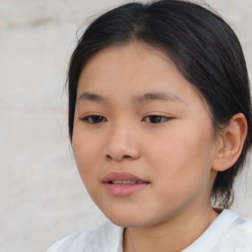 Joyful asian child female with medium  brown hair and brown eyes