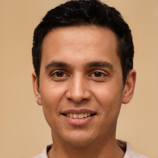 Joyful white young-adult male with short  black hair and brown eyes