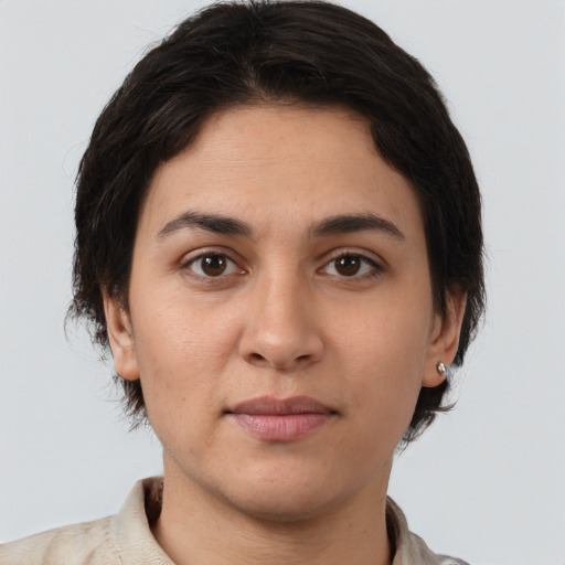 Joyful white young-adult female with short  brown hair and brown eyes