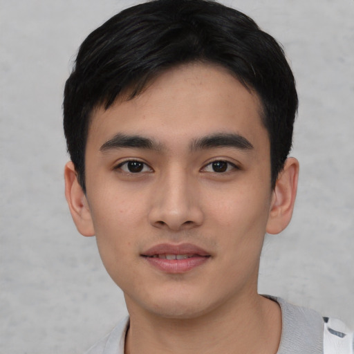 Joyful asian young-adult male with short  black hair and brown eyes