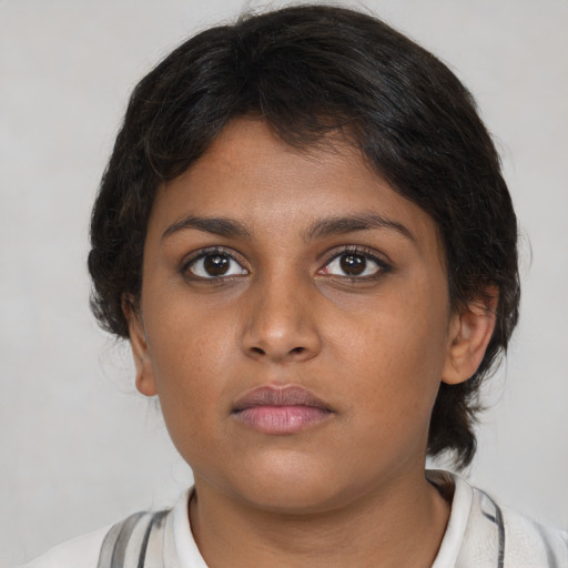 Neutral black young-adult female with medium  brown hair and brown eyes