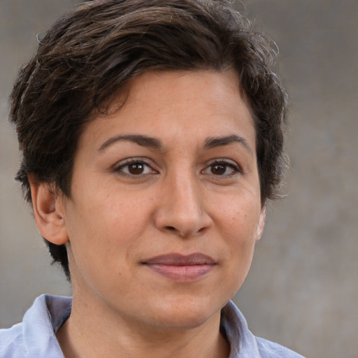 Joyful white adult female with short  brown hair and brown eyes