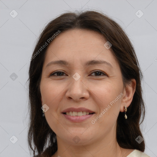 Joyful white adult female with long  brown hair and brown eyes