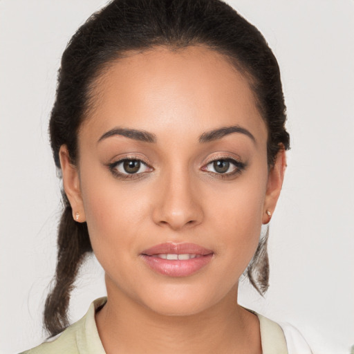 Joyful white young-adult female with long  brown hair and brown eyes