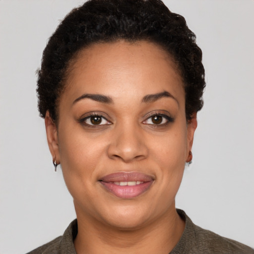 Joyful latino young-adult female with short  black hair and brown eyes