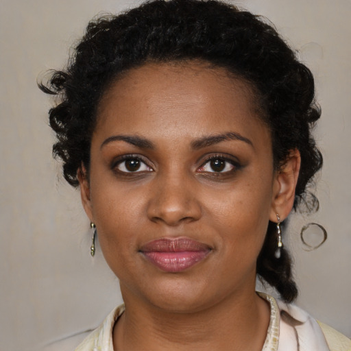 Joyful black young-adult female with medium  brown hair and brown eyes