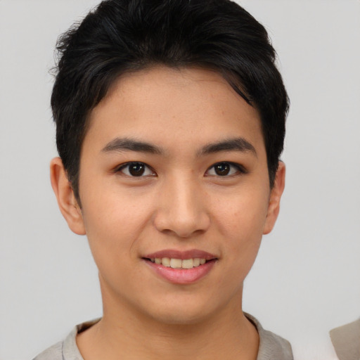 Joyful asian young-adult female with short  brown hair and brown eyes