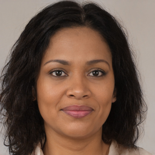 Joyful black young-adult female with medium  brown hair and brown eyes