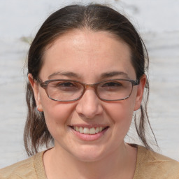 Joyful white adult female with medium  brown hair and brown eyes