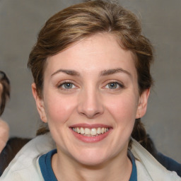 Joyful white young-adult female with medium  brown hair and blue eyes