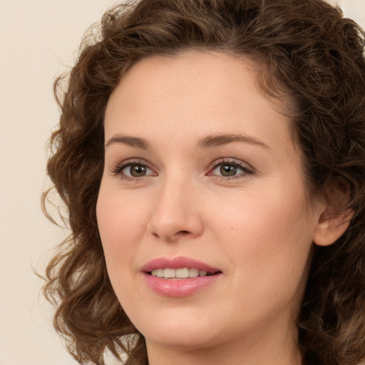 Joyful white young-adult female with long  brown hair and green eyes