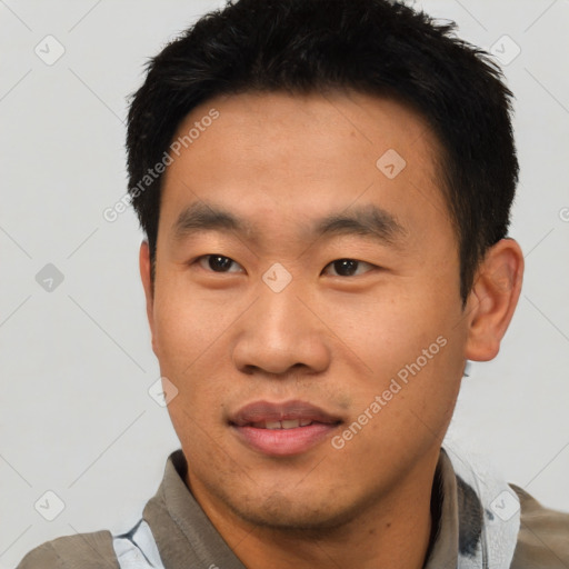 Joyful asian young-adult male with short  black hair and brown eyes