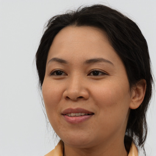 Joyful asian adult female with medium  brown hair and brown eyes