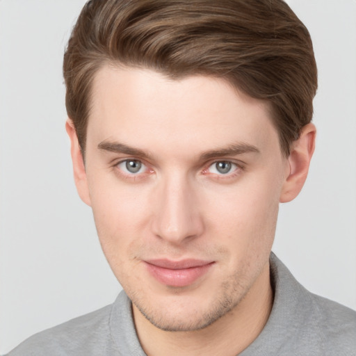 Joyful white young-adult male with short  brown hair and grey eyes