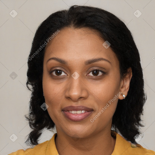 Joyful black adult female with medium  brown hair and brown eyes