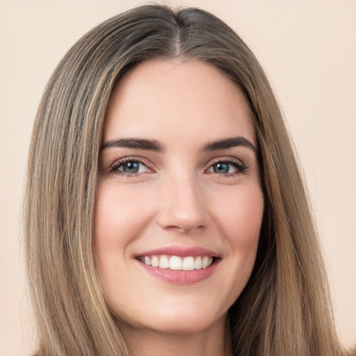 Joyful white young-adult female with long  brown hair and brown eyes