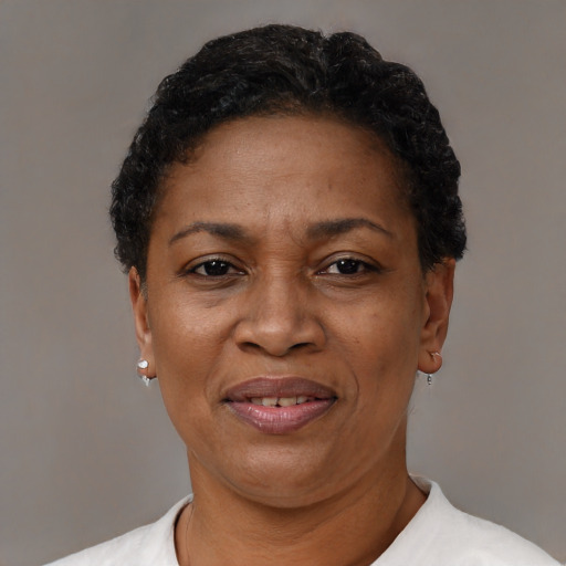 Joyful black adult female with short  black hair and brown eyes