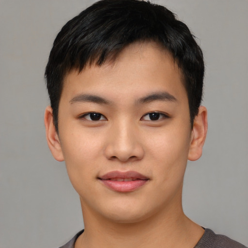 Joyful asian young-adult male with short  black hair and brown eyes