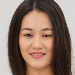 Joyful asian young-adult female with long  brown hair and brown eyes