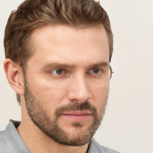 Joyful white adult male with short  brown hair and grey eyes