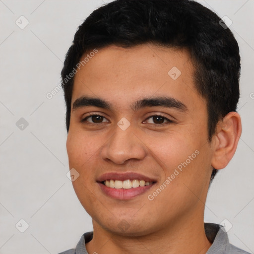 Joyful asian young-adult male with short  black hair and brown eyes