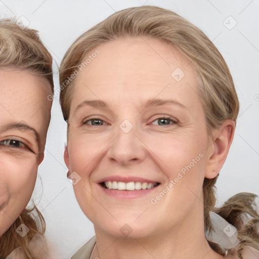 Joyful white adult female with medium  brown hair and blue eyes