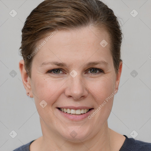 Joyful white adult female with short  brown hair and grey eyes