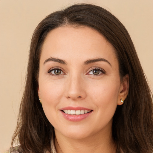 Joyful white young-adult female with long  brown hair and brown eyes