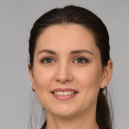 Joyful white young-adult female with medium  brown hair and brown eyes