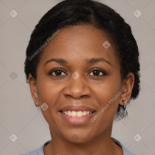 Joyful black adult female with short  black hair and brown eyes