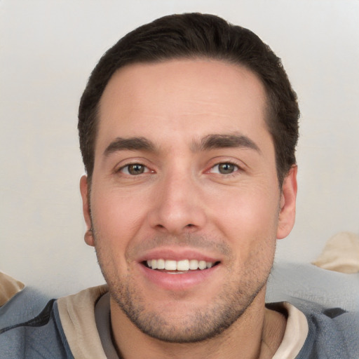 Joyful white young-adult male with short  black hair and brown eyes