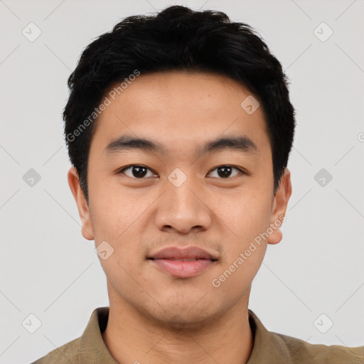 Joyful asian young-adult male with short  black hair and brown eyes