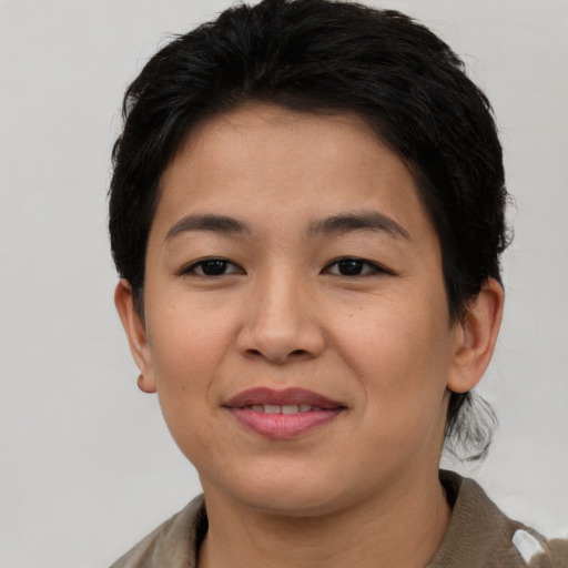 Joyful asian young-adult female with short  brown hair and brown eyes