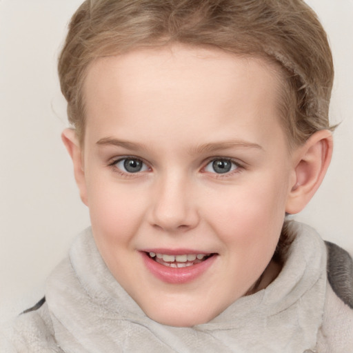 Joyful white child female with short  brown hair and blue eyes